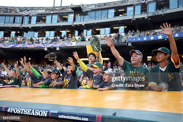 Oakland Athletics fans cheer against the Detroit Tigers during Game One of the American League Division Series at O.co Coliseum on October 4, 2013 in...