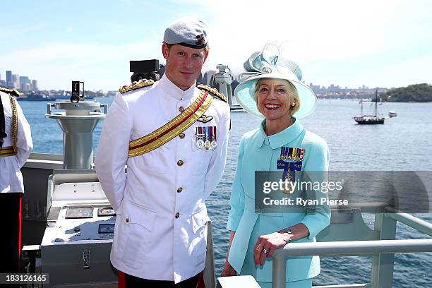 Prince Harry and Governor-General Quentin Bryce pose onboard the HMAS Leeuwin as they participate in the 2013 International Fleet Review on October...