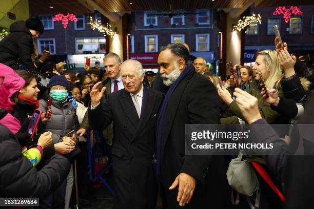 Britain's King Charles III visits the Christmas Market at Ealing Broadway Shopping Centre in west London on December 7 where he meets local business...