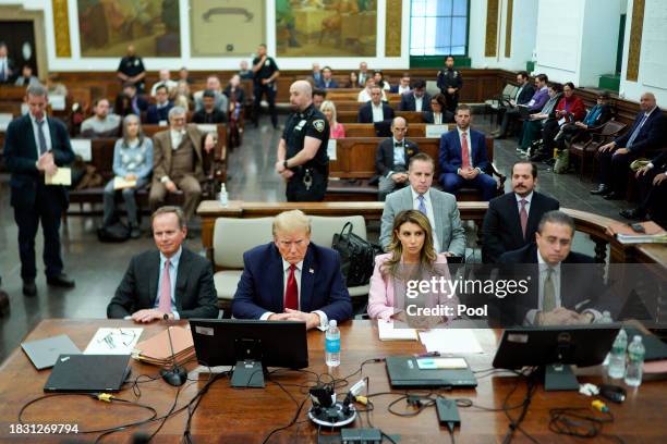 Former U.S. President Donald Trump sits at the defense table with his attorneys Christopher Kise and Alina Habba in New York State Supreme Court on...