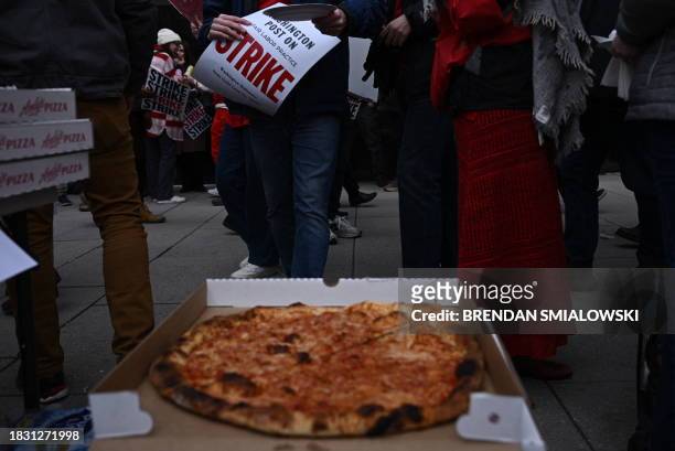 Pizzas are brought to employees of the Washington Post, as well as supporters, as they walk the picket line during a 24 hour strike, outside of...
