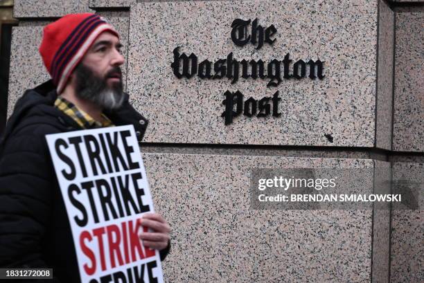 Employees of the Washington Post, joined by supporters, walk the picket line during a 24 hour strike, outside of Washington Post headquarters in...