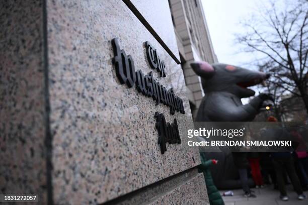 Sign for the Washignton Post is displayed as employees of the Washington Post, joined by supporters, walk the picket line during a 24 hour strike,...