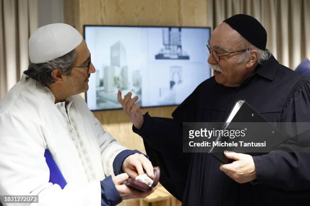 Rabbi Andreas Nachama and Imam Kadir Sanci chat ahead of a multi religious prayer to celebrate the beginning of Hanukkah on December 7, 2023 in...