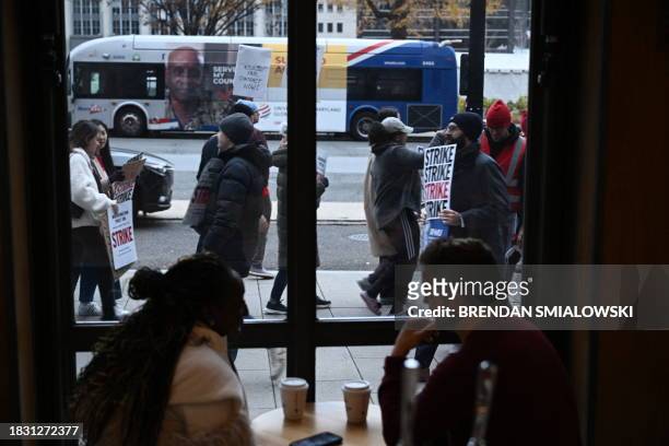 Employees of the Washington Post, joined by supporters, walk the picket line during a 24 hour strike, outside of Washington Post headquarters in...
