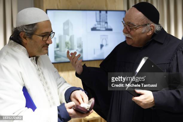 Rabbi Andreas Nachama and Imam Kadir Sanci chat ahead of a multi religious prayer to celebrate the beginning of Hanukkah on December 7, 2023 in...
