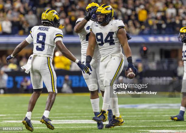Kris Jenkins of the Michigan Wolverines celebrates a turnover during the Big Ten Championship against the Iowa Hawkeyes at Lucas Oil Stadium on...
