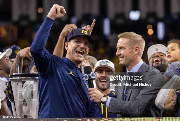 Head coach Jim Harbaugh of the Michigan Wolverines is seen on stage following the Big Ten Championship against the Iowa Hawkeyes at Lucas Oil Stadium...