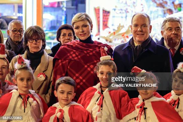 Prince Albert II of Monaco , Princess Charlene of Monaco and Princess Stephanie of Monaco pose for a photograph as they attend the inauguration of...