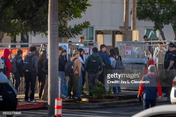 Redondo Beach, CA Students stand in line for additional security measures, including bag searches and passing through metal detectors, at entrances...