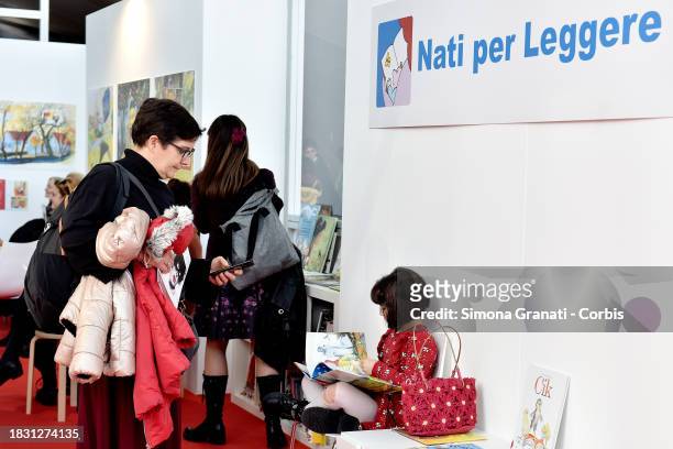 Children read and listen to stories at the Nati per Leggere stand of Più Libri Più Liberi, the small and medium publishing fair, on December 7, 2023...