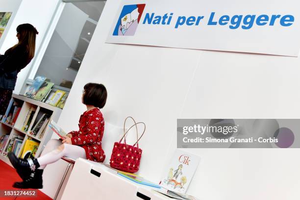 Children read and listen to stories at the Nati per Leggere stand of Più Libri Più Liberi, the small and medium publishing fair, on December 7, 2023...