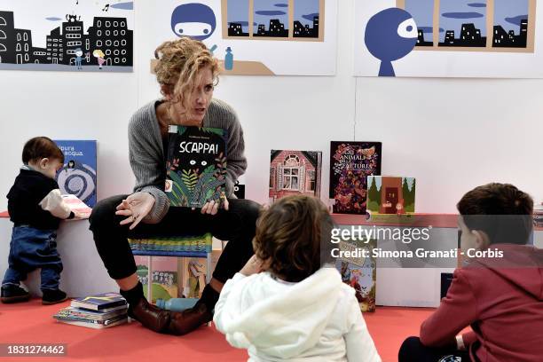 Children read and listen to stories at the Nati per Leggere stand of Più Libri Più Liberi, the small and medium publishing fair, on December 7, 2023...