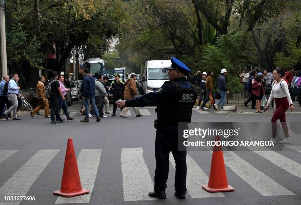 Policeman directs traffic after an earthquake in Mexico City on December 7, 2023. A 5.8-magnitude earthquake shook much of central Mexico Thursday...