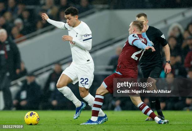 Brennan Johnson of Tottenham Hotspur and Jarrod Bowen of West Ham United challenge during the Premier League match between Tottenham Hotspur and West...