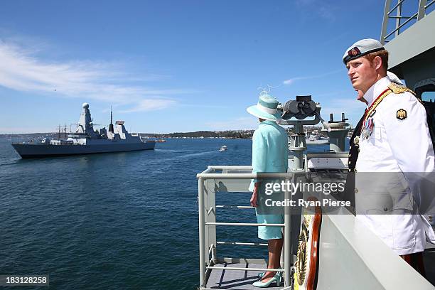 Prince Harry and Governor-General Quentin Bryce look out onto Sydney Harbour onboard the HMAS Leeuwin as they participate in the 2013 International...