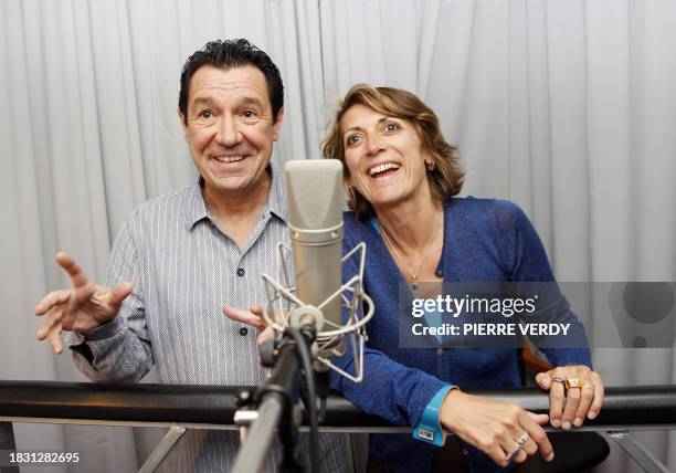 Recent picture of French actors Philippe Peythieu and Veronique Augereau sharing a smile, 11 July 2007 in a recording studio in Paris, during the...