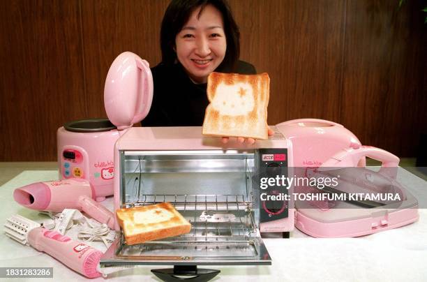 Yukari Miyashita of Sanyo Electric's Tokyo Corporate Communications shows off a slice of bread toasted by Sanyo's new oven toaster of "Hello Kitty"...