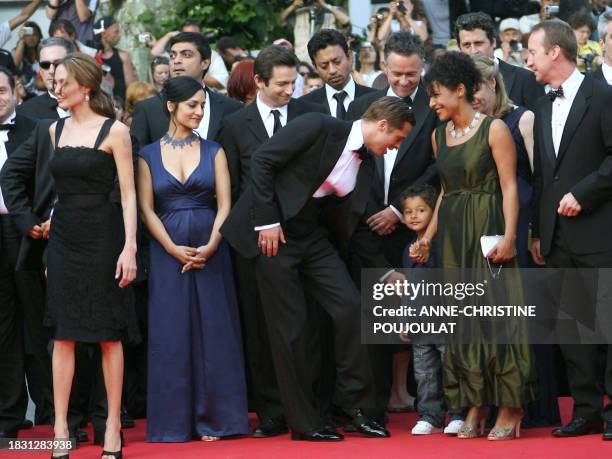 Actor and producer Brad Pitt talks 21 May 2007 to Adam Pearl, son of murdered journalist Daniel Pearl, as he arrives with US actress Angelina Jolie,...