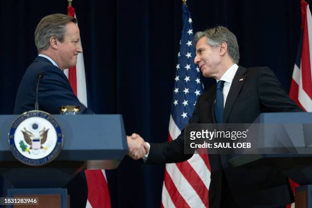 Secretary of State Antony Blinken and British Foreign Secretary David Cameron shake hands during a press conference at the State Department in...