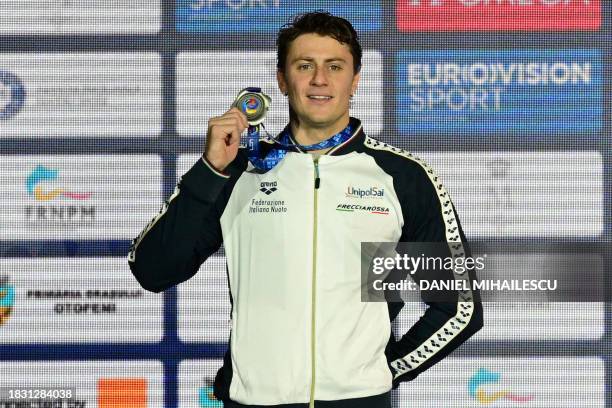 Second placed Italy's Nicolo Martinenghi poses on the podium after the Men's 100m Breaststroke final of the European Short Course Swimming...