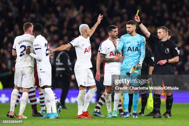 Dejan Kulusevski of Tottenham Hotspur has to be held back by his teammates as he tries to get in the face of referee Michael Salisbury after a his...