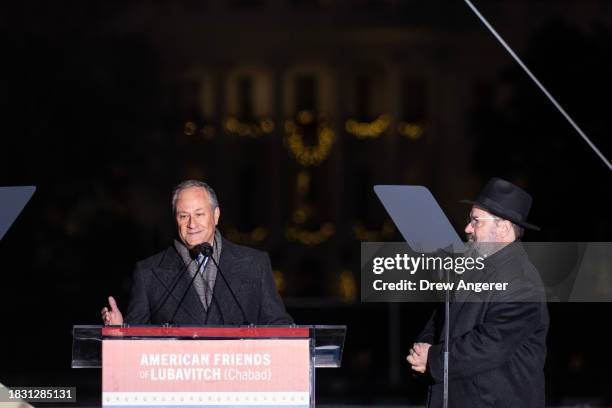 Second gentleman Douglas Emhoff speaks as Rabbi Levi Shemtov, executive vice president of American Friends of Lubavitch, looks on during the National...