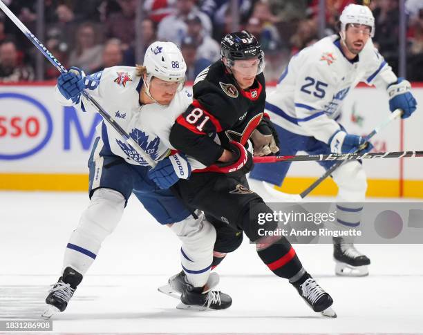 Dominik Kubalik of the Ottawa Senators battles for position against William Nylander of the Toronto Maple Leafs during the first period at Canadian...