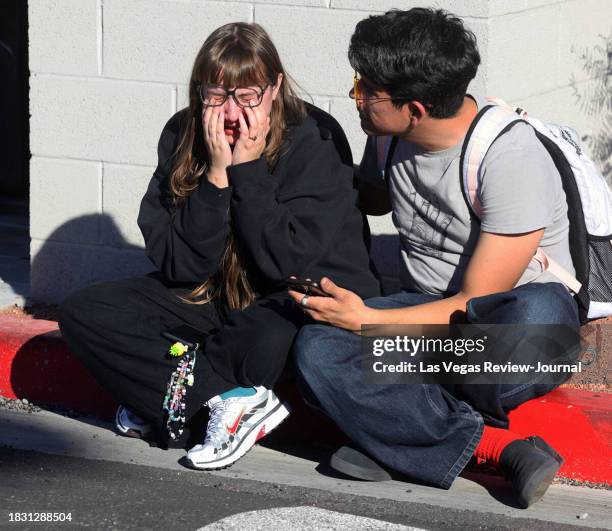 Amanda Perez is comforted by fellow student Alejandro Barron near Maryland Parkway following a shooting on the UNLV campus in Las Vegas Wednesday,...