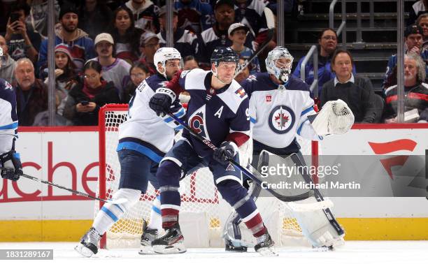Mikko Rantanen of the Colorado Avalanche skates against Dylan DeMelo of the Winnipeg Jets at Ball Arena on December 7, 2023 in Denver, Colorado.