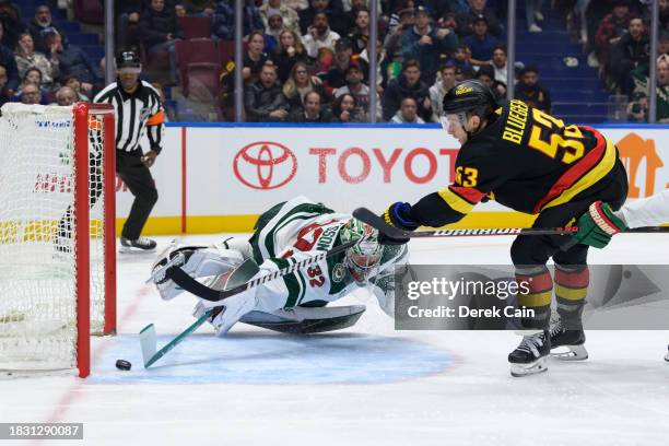 Teddy Blueger of the Vancouver Canucks scores a goal on Filip Gustavsson of the Minnesota Wild during the third period of their NHL game at Rogers...