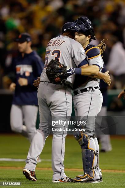 Joaquin Benoit of the Detroit Tigers and Alex Avila celebrate defeating the Oakland Athletics in Game One of the American League Division Series at...