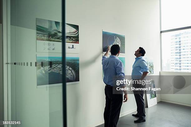 two office workers talking - poster presentation stock pictures, royalty-free photos & images