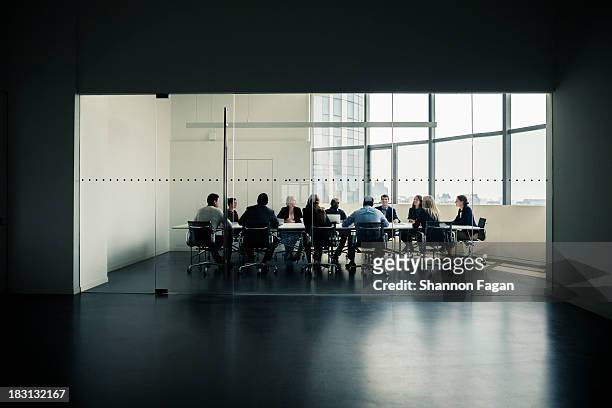 group of business people having a business meeting - board room stock-fotos und bilder