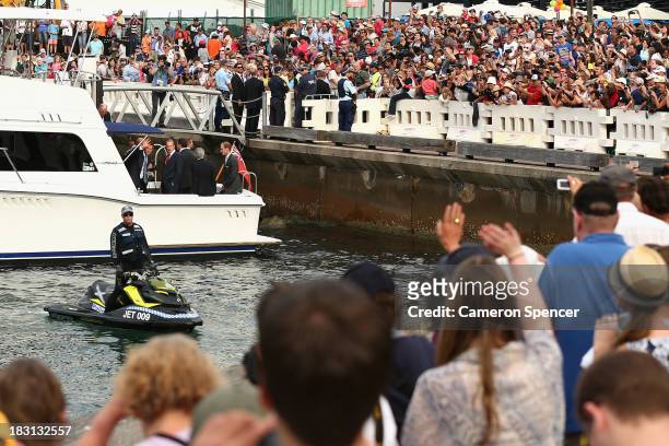Prince Harry waves to spectators after boarding a boat bound for Kirribilli during the International Fleet Review on October 5, 2013 in Sydney,...