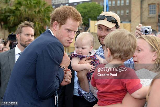 Prince Harry is greeted by members of the public at Campbell's Cove during the 2013 International Fleet Review on October 5, 2013 in Sydney,...