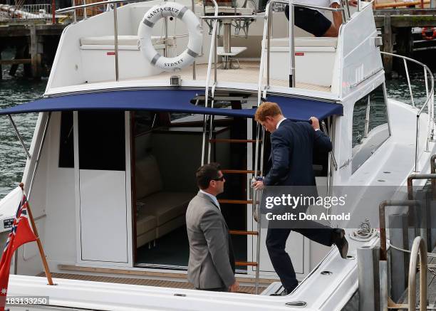 Prince Harry hops on a boat at Campbell Cove on October 5, 2013 in Sydney, Australia. Over 50 ships participate in the International Fleet Review at...