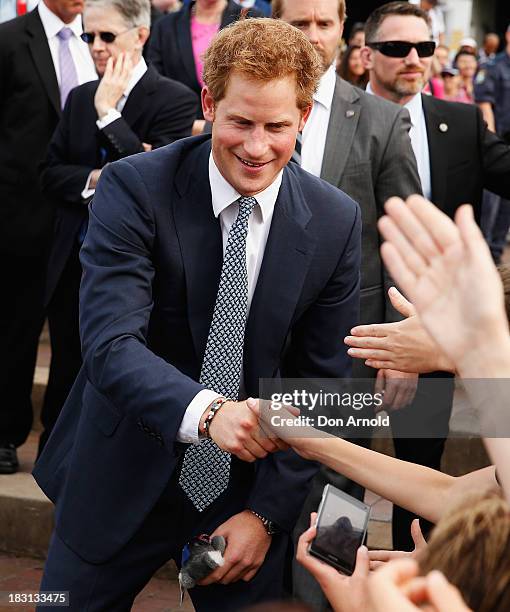 Prince Harry greets members of the public at Campbell Cove on October 5, 2013 in Sydney, Australia. Over 50 ships participate in the International...