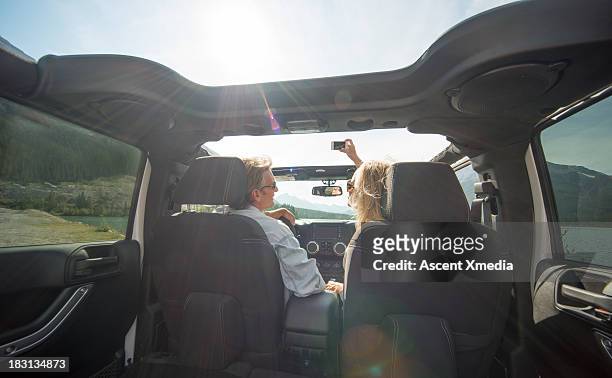 interior view of couple driving jeep, mtn road - jeep stock pictures, royalty-free photos & images