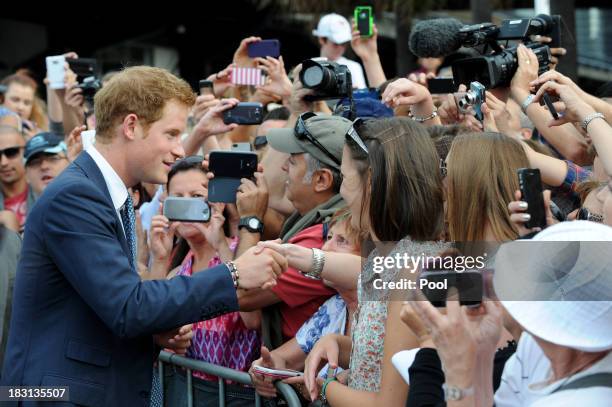 Prince Harry is greeted by members of the public at Campbell's Cove during the 2013 International Fleet Review on October 5, 2013 in Sydney,...