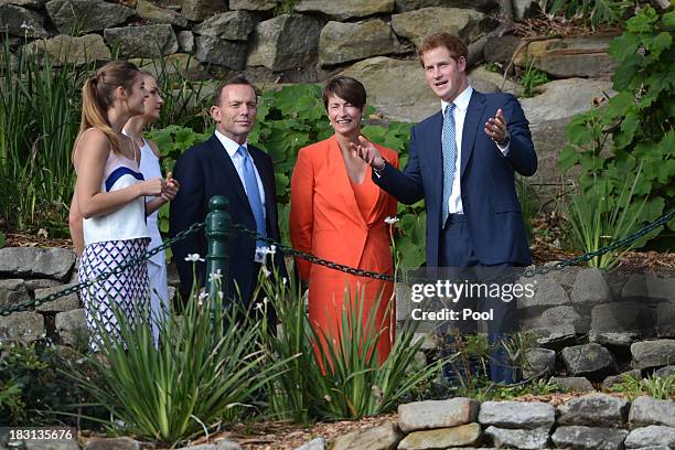 Prince Harry looks out over Sydney Harbour with Prime Minister Tony Abbott, his wife Margie and daughters Bridget and Frances after arriving at...