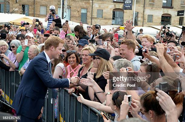 Prince Harry is greeted by members of the public at Campbell's Cove during the 2013 International Fleet Review on October 5, 2013 in Sydney,...