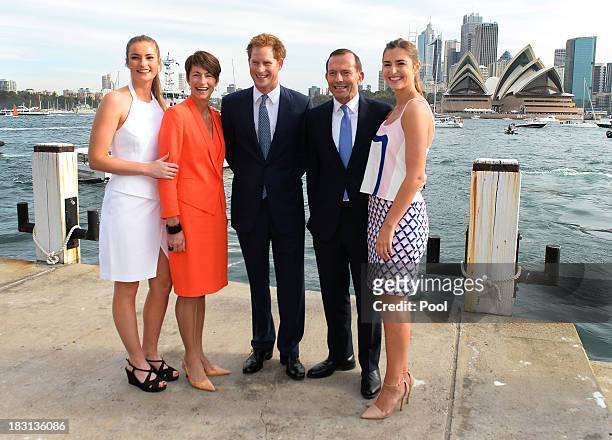 Prince Harry is greeted by Australian Prime Minister Tony Abbott his wife Margie and daughters Bridget and Francis at the steps to Kirribilli House...