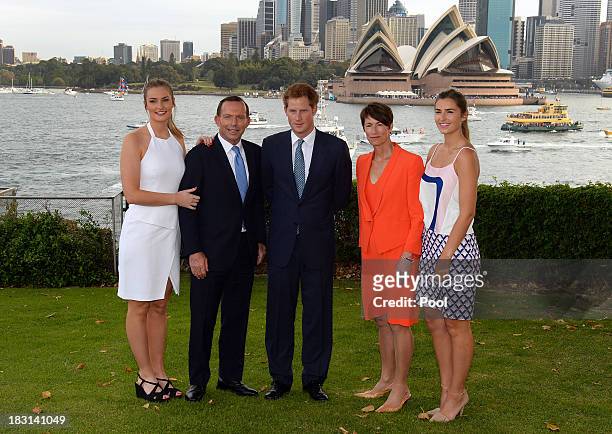Prince Harry is greeted by Australian Prime Minister Tony Abbott his wife Margie and daughters Bridget and Francis at the steps to Kirribilli House...