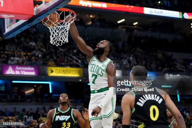 Jaylen Brown of the Boston Celtics dunks the ball past Myles Turner and Tyrese Haliburton of the Indiana Pacers in the first quarter during the NBA...