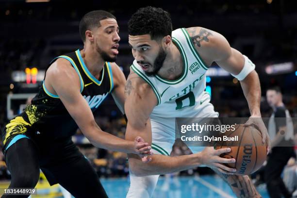 Jayson Tatum of the Boston Celtics handles the ball while being guarded by Tyrese Haliburton of the Indiana Pacers in the first quarter during the...