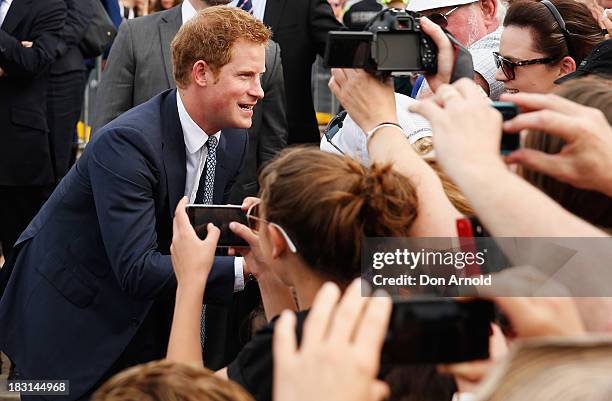 Prince Harry greets members of the public at Campbell Cove on October 5, 2013 in Sydney, Australia. Over 50 ships participate in the International...