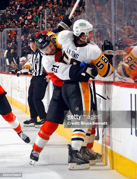 Scott Laughton of the Philadelphia Flyers ties up Kris Letang of the Pittsburgh Penguins during the second period at the Wells Fargo Center on...