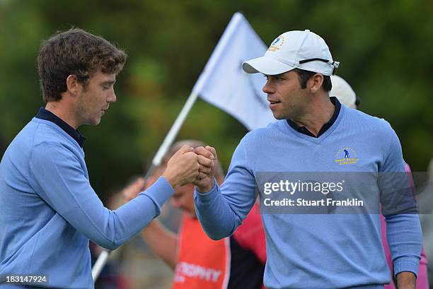 Paul Casey of the Great Britain and Ireland team celebrates with palying partner Tommy Fleetwood during the third day's morning foursomes at the Seve...