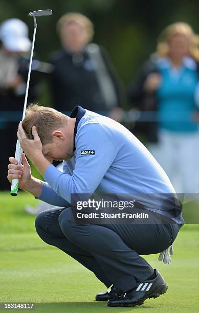 Stephen Gallacher of the Great Britain and Ireland team reacts to a putt during the third day's morning foursomes at the Seve Trophy at Golf de...